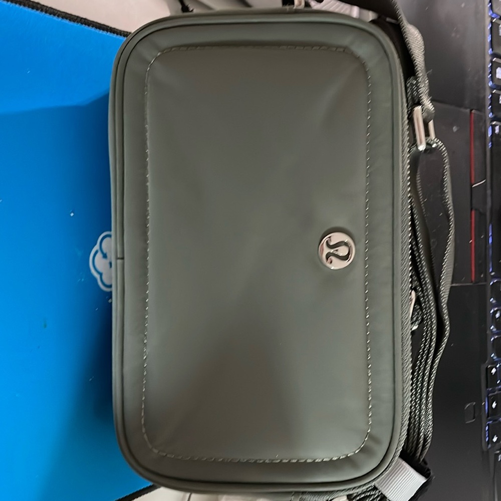 🍋LULULEMON | Crossbody Camera Bag in Grey, two zip pockets, strap drop is 26”.